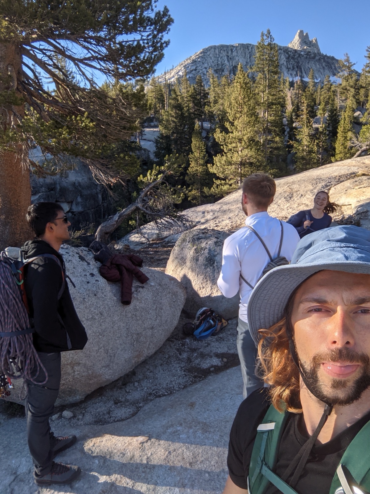 Gearing up on the granite with a peak behind us