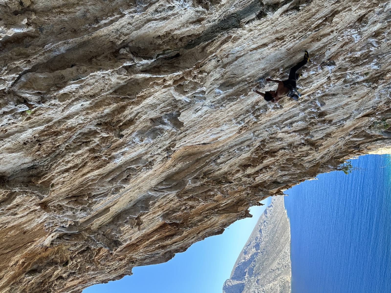 Side view of a move around the fifth bolt, sea and headland below