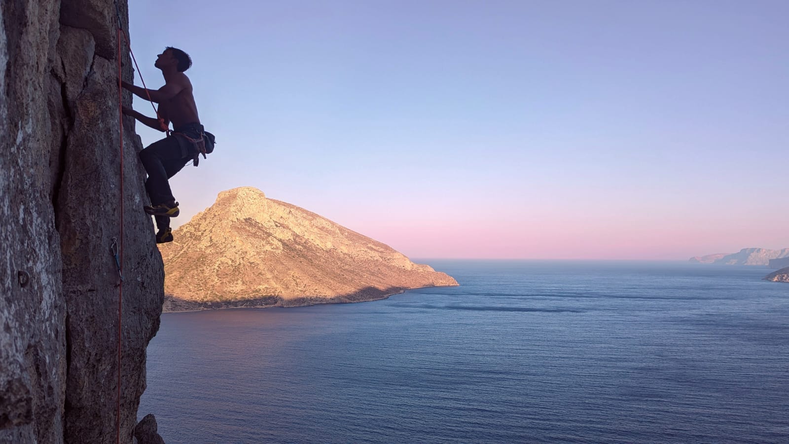 A wide morning view of the crag and the sea