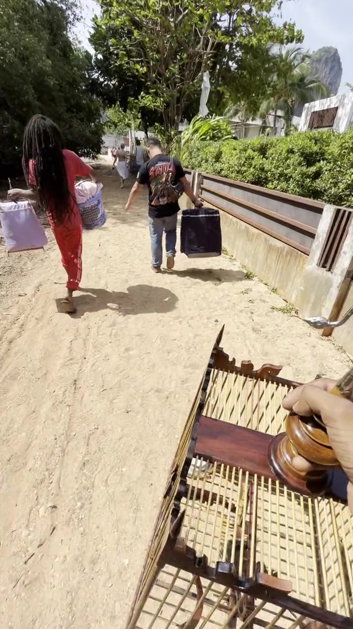 Carrying a singing bird to the longtail boat